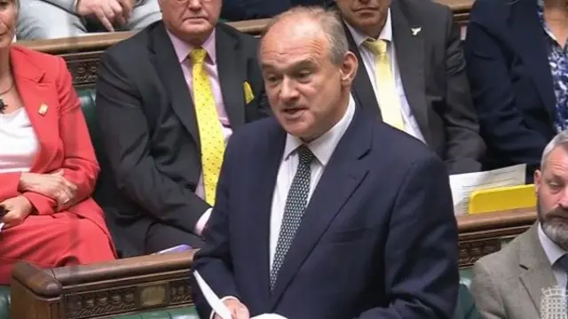 Ed Davey, wearing a dark suit, speaking in the House of Commons