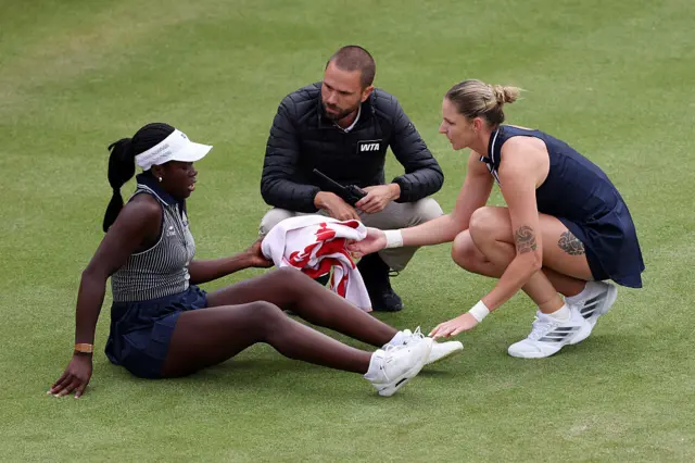 Victoria Mboko of Canada is checked on by the chair and Karolina Pliskova umpire