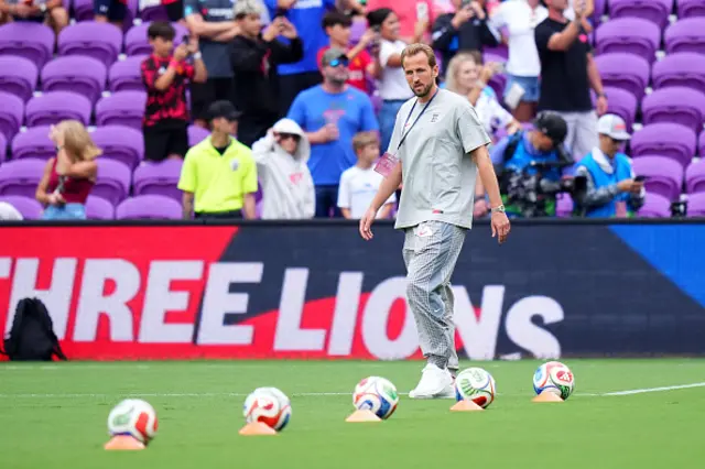 Harry Kane of England inspects the pitch