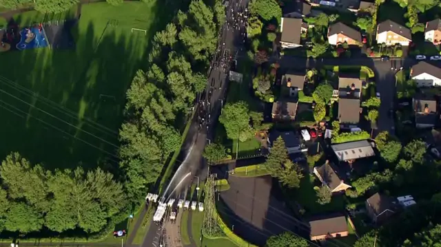 Aerial view of police using water cannon on protestors