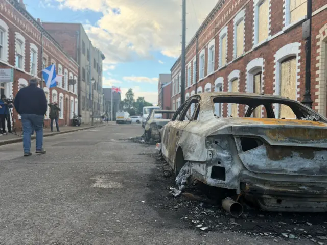 Street with burnt out car