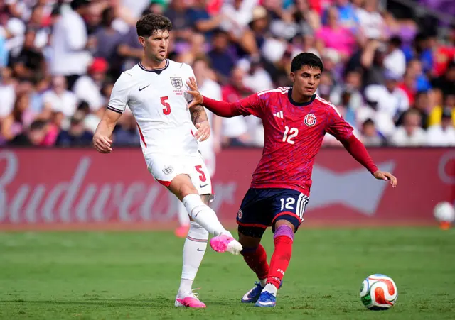 John Stones passes the ball whilst under pressure from Andrey Soto