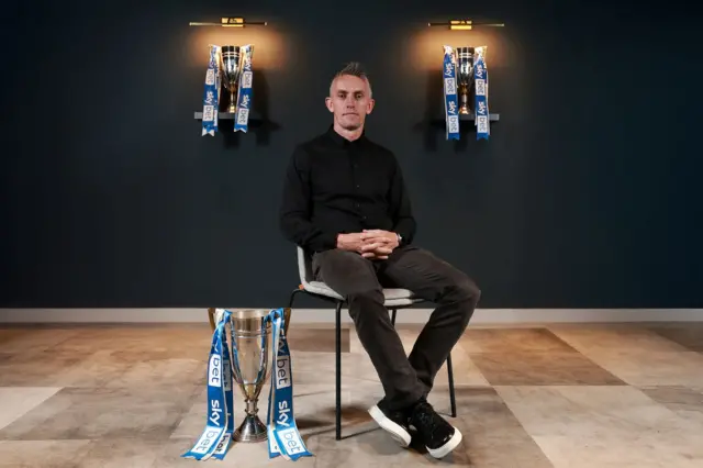 Ipswich Town manager Kieran McKenna with promotion trophies