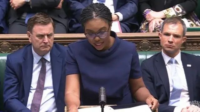 Kemi Badenoch, wearing a dark blue outfit, speaking in the House of Commons
