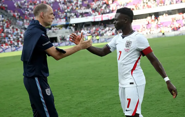Bukayo Saka shakes hands with Thomas Tuchel