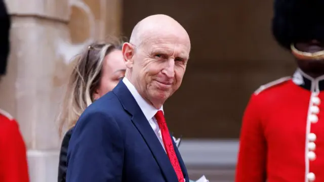 John Healey in front of some beefeaters
