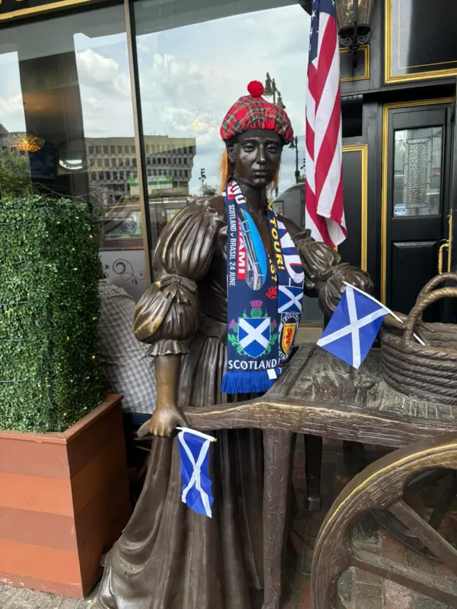 Scotland fans dress up a statue in Boston with scarves and flags