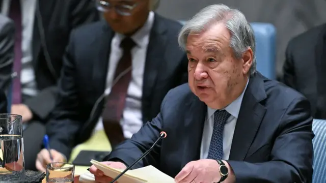 A photo of Antonio Guterres speaking into a microphone at an event