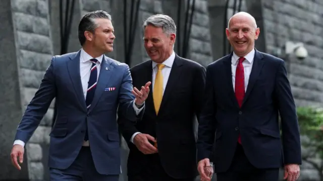 John Healey walks alongside Pete Hegseth and Richard Marles, the three laugh together