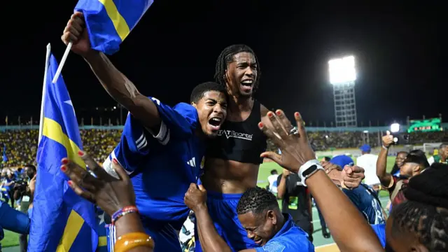 Curaçao players and fans celebrate World Cup 2026 qualification after a 0-0 draw with Jamaica at the National Stadium in Kingston, Jamaica on November 18, 2025.