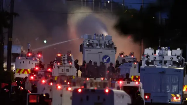 Police fire a water cannon after attack at Sandyknowes roundabout