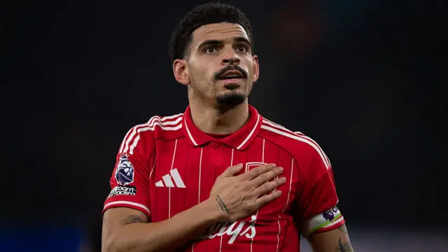Morgan Gibbs-White touching the Nottingham Forest badge
