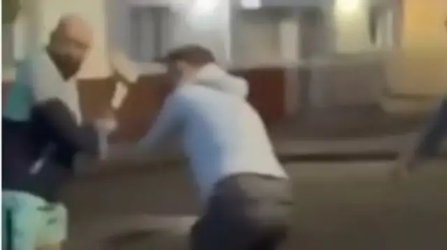A freeze frame of Maitiu Mág Tighearnán (left) captured in footage of his intervention, with the alleged attacker out of sight on the ground