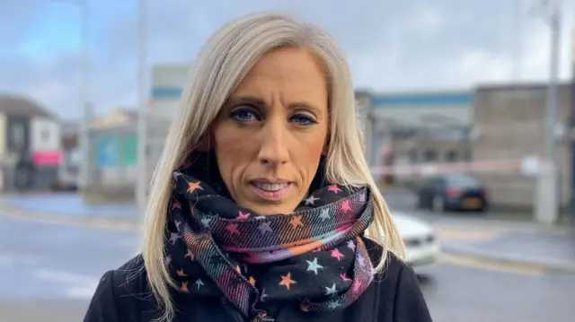Carla Lockhart, wearing a scarf and navy jacket