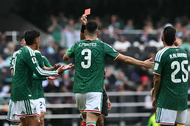 Cesar Montes is shown a red card