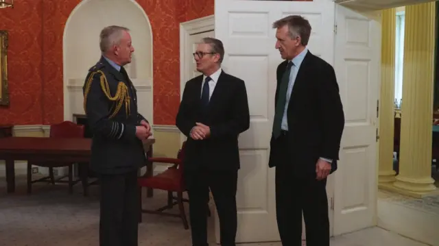 Richard Knighton, left, Keir Starmer, centre, and Dan Jarvis, right, are standing chatting inside a room at Downing Street