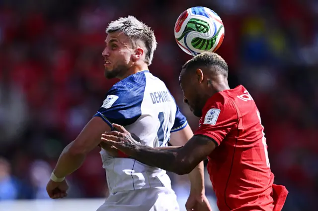 Ermedin Demirovic of Bosnia & Herzegovina competes for the ball with Derek Cornelius