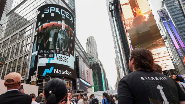 SpaceX founder and CEO Elon Musk is shown on a screen celebrating the company's debut on the Nasdaq market in New York, New York, USA, 12 June 2026