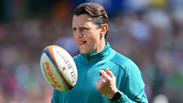 Northampton Saints director of rugby Phil Dowson spinning the ball with his hands before a match.