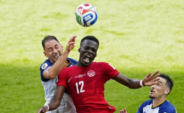 Canada's Tani Oluwaseyi in action with Bosnia and Herzegovina's Nikola Katic and Ivan Basic