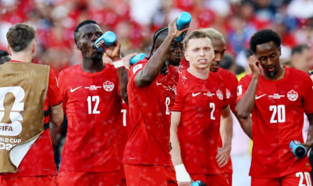 Canada's Ismael Kone pours water on his head