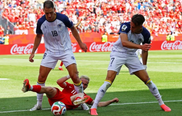Bosnia and Herzegovina's Nikola Katic and Amar Dedic in action with Canada's Liam Millar