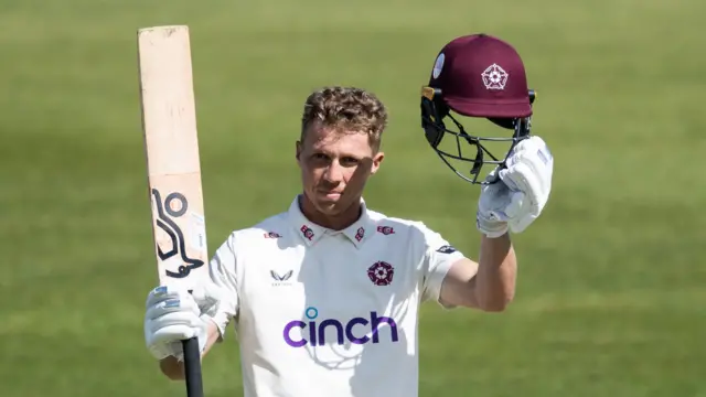 Northamptonshire's Nathan McSweeney raises his bat after scoring a hundred