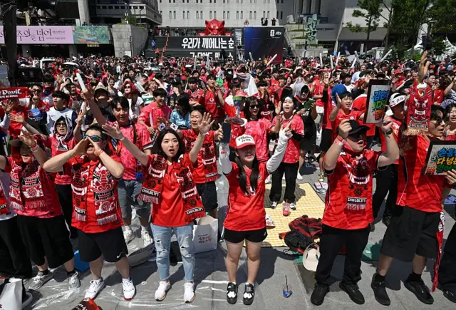South Korea supporters watch the football