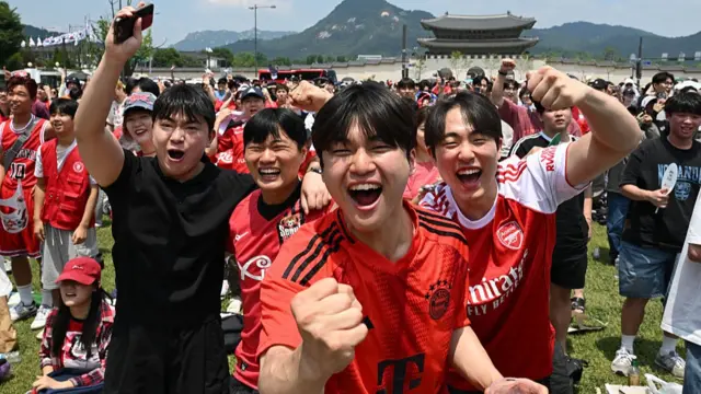 Football fans of South Korea react as they watch the 2026 World Cup football match between South Korea and the Czech Republic on big screens in Seoul