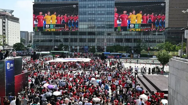 Football fans of South Korea react as they watch the 2026 World Cup football match between South Korea and the Czech Republic on big screens in Seoul