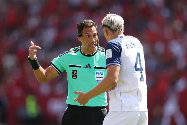 Tarik Muharemovic #4 of Bosnia and Herzegovina argues a call with referee Facundo Tello