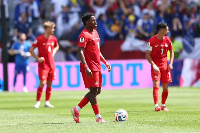 A dejected looking Jonathan David of Canada stands with the team