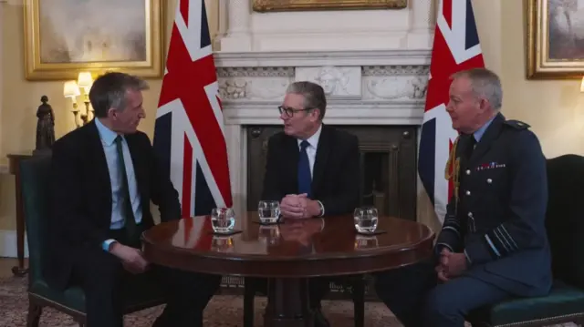 Dan Jarvis, left, Keir Starmer, centre, and Richard Knighton, right, chat as they sit around a table at Downing Street