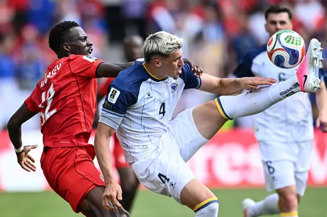 Tani Oluwaseyi of Canada competes for the ball with Tarik Muharemovic