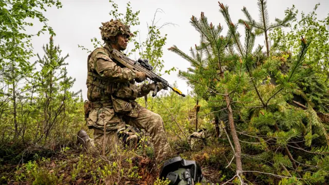 British Army soldiers from 3 Rifles watch for enemy forces at their Forward Line of Own Troops (FLOT) in an undisclosed training ground less than 50 kilometres from the Russian border in Finland, 26 May