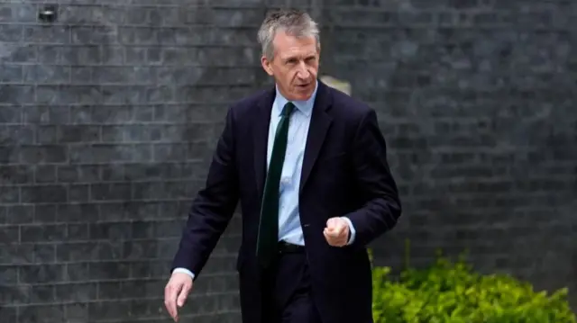 Dan Jarvis looks towards the camera as he walks past