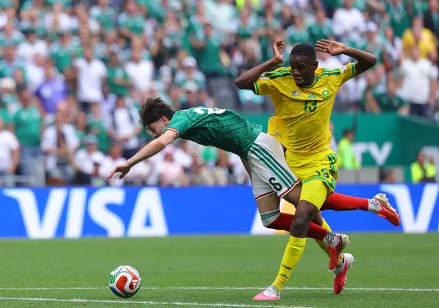Yaya Sithole tangles legs with Brian Gutierrez