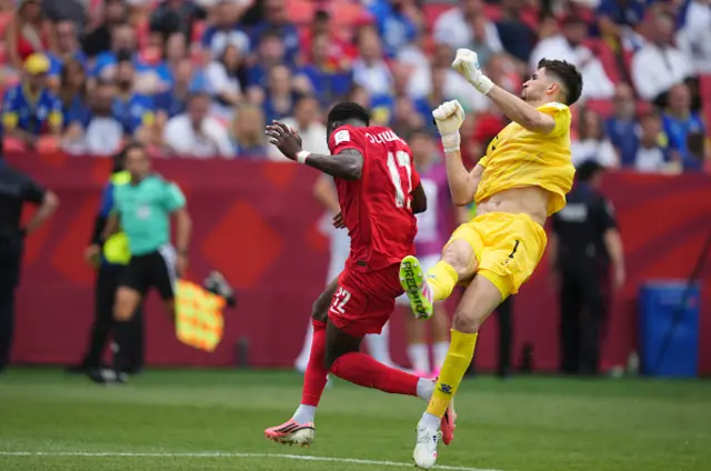 Nikola Vasilj (Bosnia And Herzegovina) and Tajon Buchanan (Canada) battle for the ball