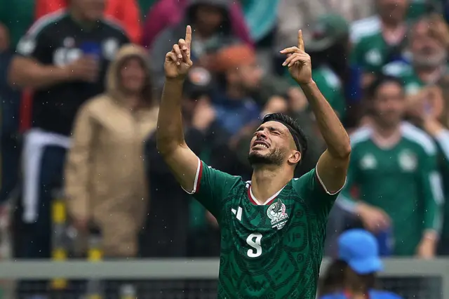 Raul Jimenez holds up his arms and points to the sky