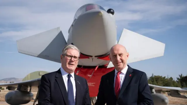 Keir Starmer pictured with the former Defence Secretary John Healey in front of a UK Typhoon fighter jet