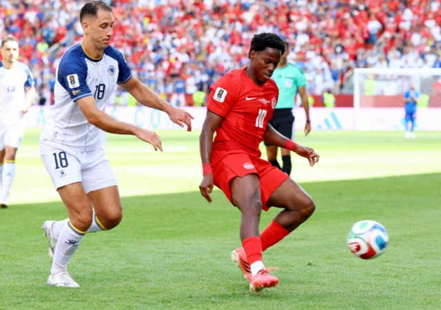 Canada's Jonathan David in action with Bosnia and Herzegovina's Nikola Katic