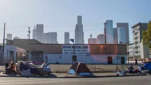 A man experiencing homelessness sits outside a tent in the Skid Row area of downtown Los Angeles on June 11, 2026, the eve of the World Cup opening match in the US. America's second biggest city will host eight games in the World Cup but faces even bigger global scrutiny in 2028 when the Olympics come to town, bringing athletes and fans from all over the world. Visitors to Los Angeles are frequently struck by the staggering levels of homelessness in a city that also has pockets of astonishing wealth.