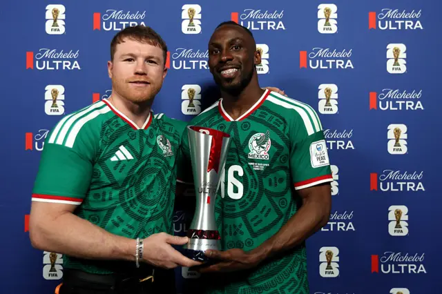 Saul 'Canelo' Alvarez poses with Julian Quinones and the Man of the Match award