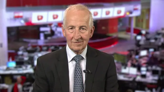 Lord Peter Ricketts sits in the New Broadcasting House newsroom, facing the camera as he speaks to BBC Breakfast