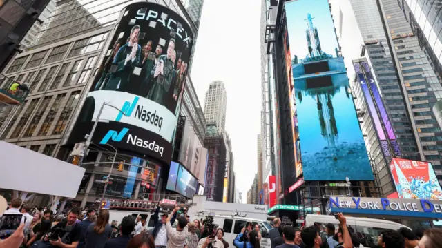 SpaceX founder and CEO Elon Musk is shown on a screen celebrating the company's debut on the Nasdaq market in New York, New York, USA, 12 June 2026
