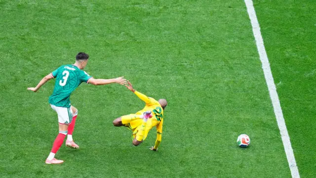 Cesar Montes of Mexico and Khuliso Mudau of South Africa compete for the ball during the FIFA World Cup 2026 Group A match between Mexico and South Africa at Mexico City Stadium on June 11, 2026 in Mexico City, Mexico.