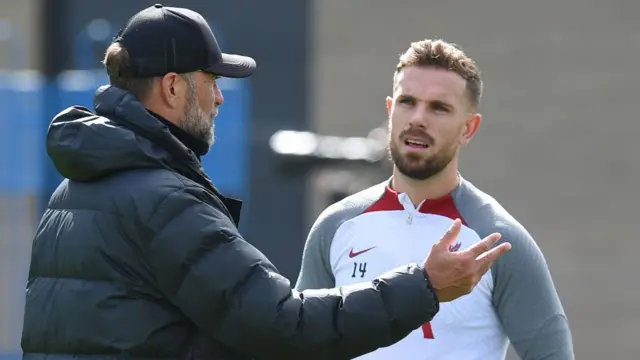 Jurgen Klopp manager of Liverpool with Jordan Henderson captain of Liverpool during a training session at AXA Training Centre on March 30, 2023 in Kirkby, England