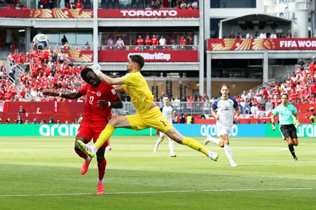 Tani Oluwaseyi #12 of Canada collides with Nikola Vasilj