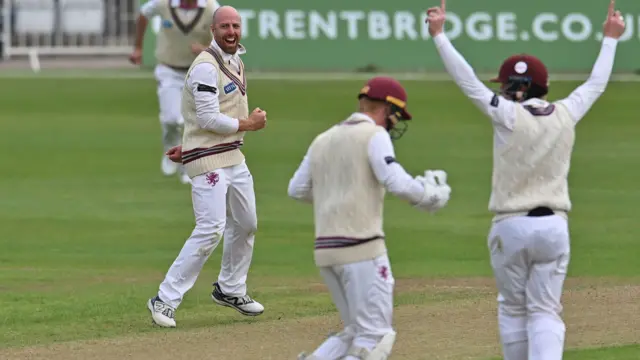 Jack Leach and the Somerset fielders celebrate the wicket of Freddie McCann