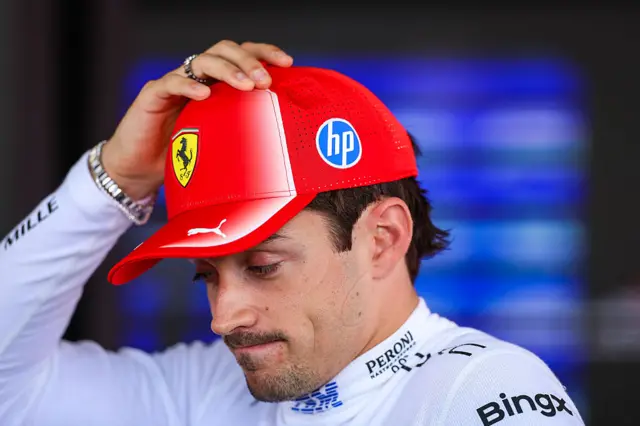 Charles Leclerc looks downcast in the media pen in Barcelona